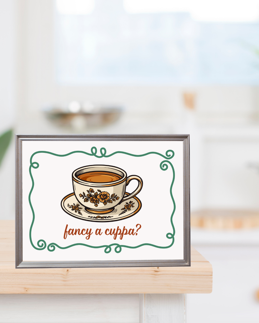 A vintage inspired printable wall art "Fancy a Cuppa?" sitting on a kitchen counter. The perfect gift for tea and coffee enthusiates.