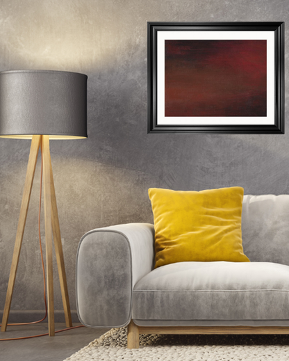 Abstract artwork with dark, blended tones of red, brown, and black, creating a moody gradient effect, hanging up in a black frame in a modern living room

