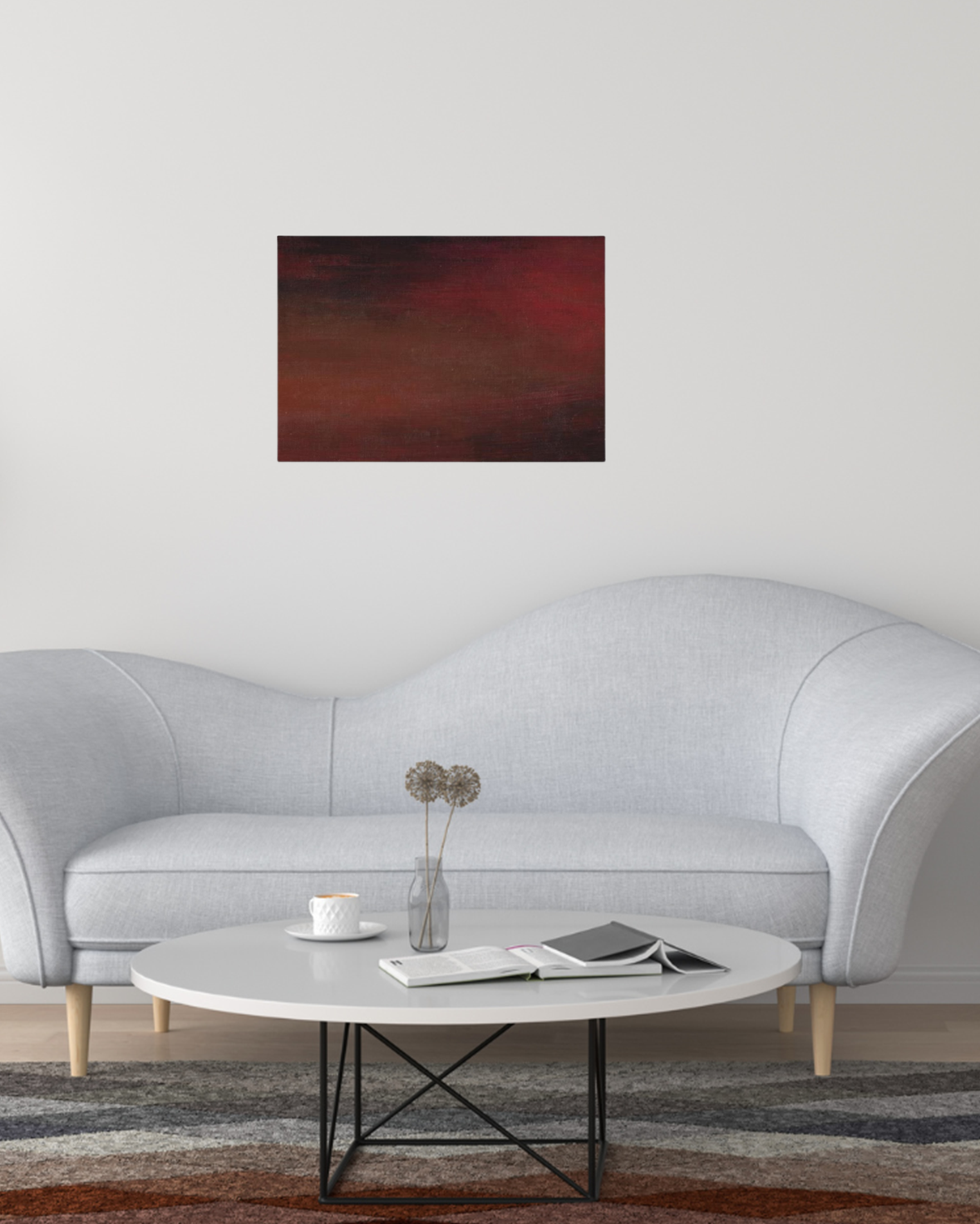 Abstract canvas art with dark, blended tones of red, brown, and black, creating a moody gradient effect hanging up in a grey modern living room