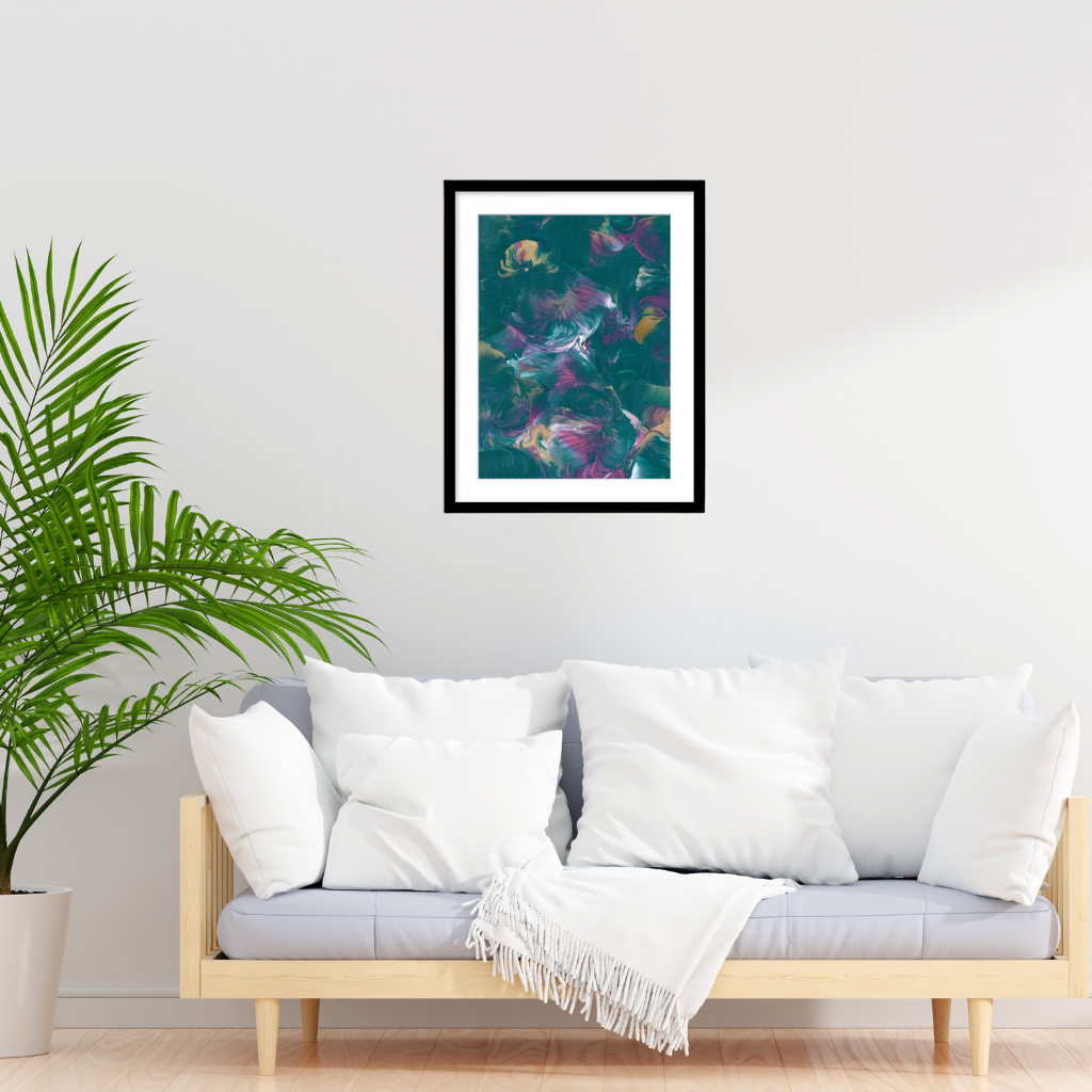 A2 framed abstract art print featuring teal, purple, and pink tones, displayed on a white wall above a light wood sofa with white cushions in a modern living room setting.